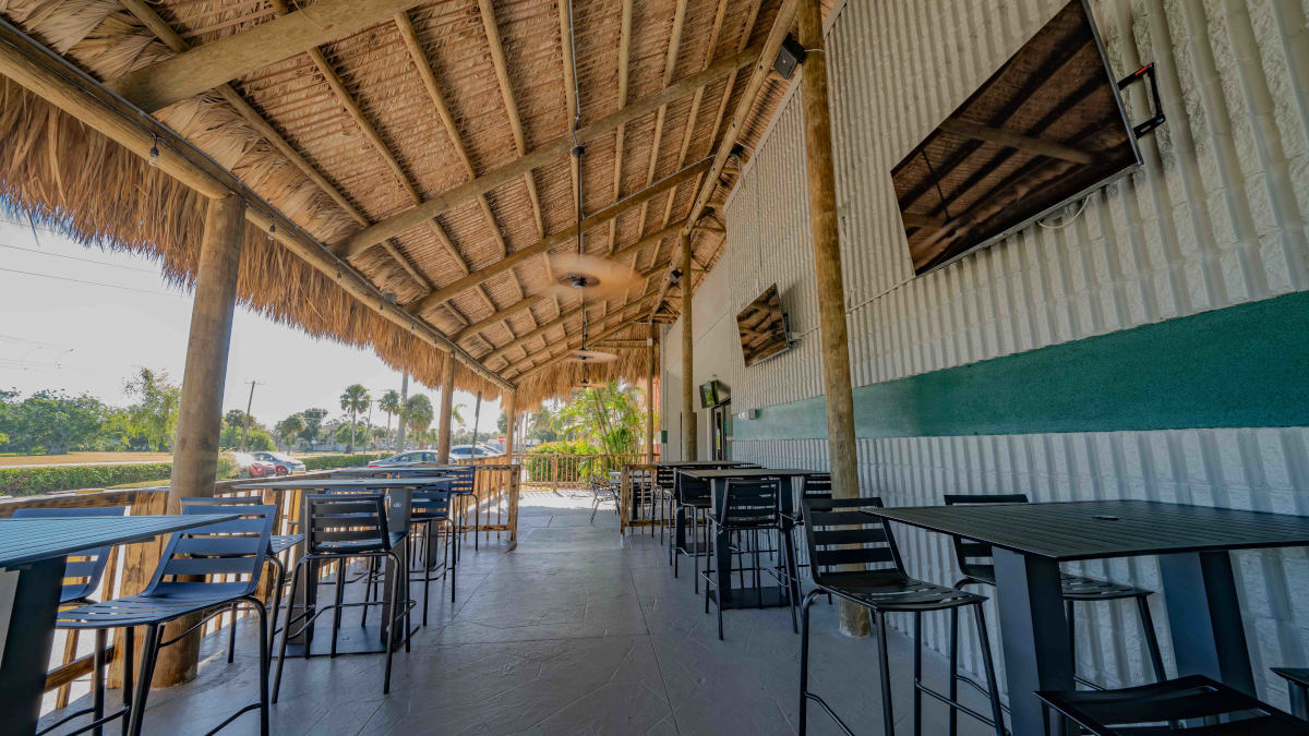 Outside bar area with tiki awning covering facing south